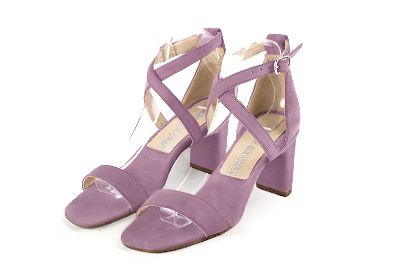  elegant sandals with crossed straps across the instep, closed at the back. . .